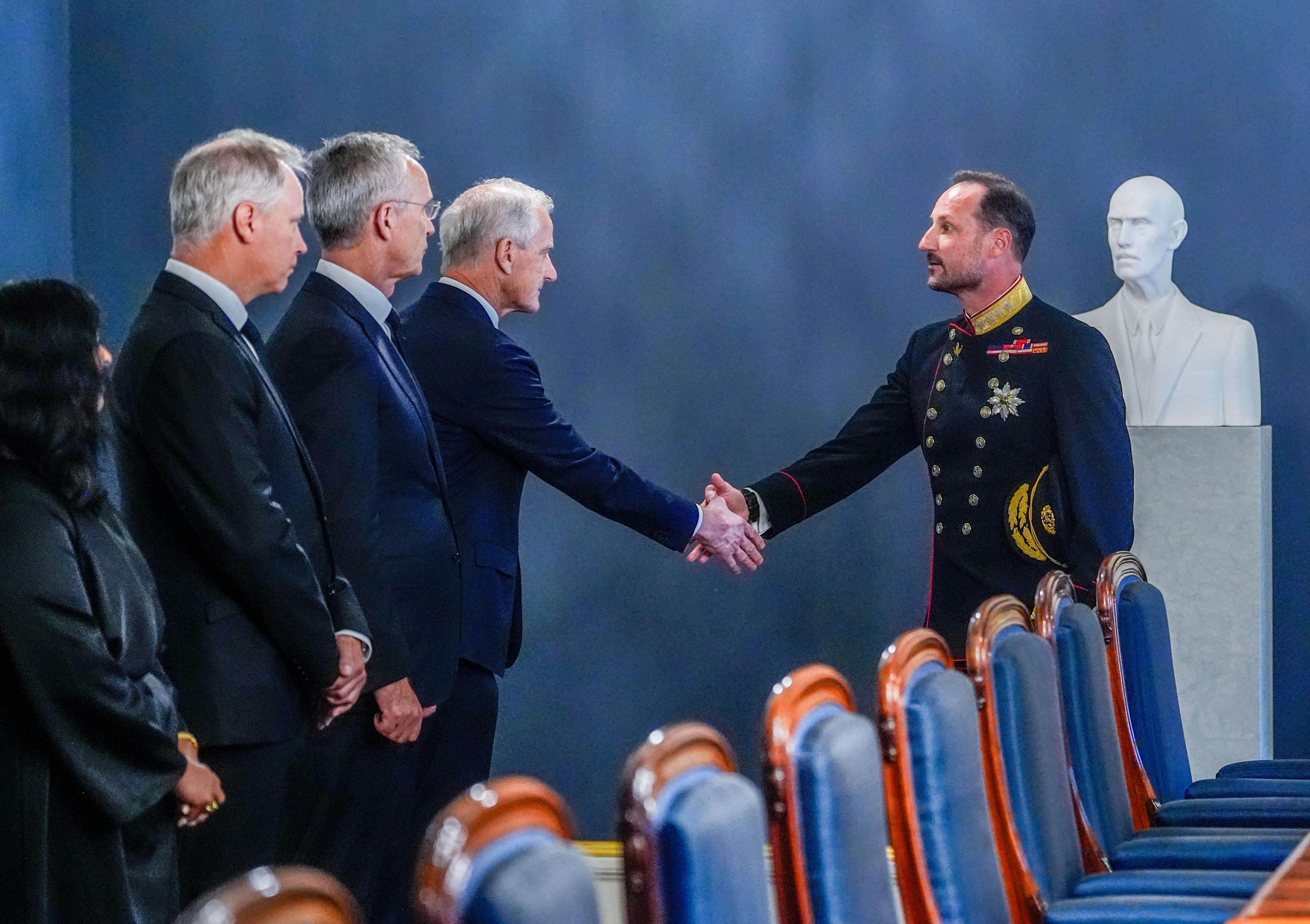 Kongen håndhilser på statsministeren i statsrådssalen.