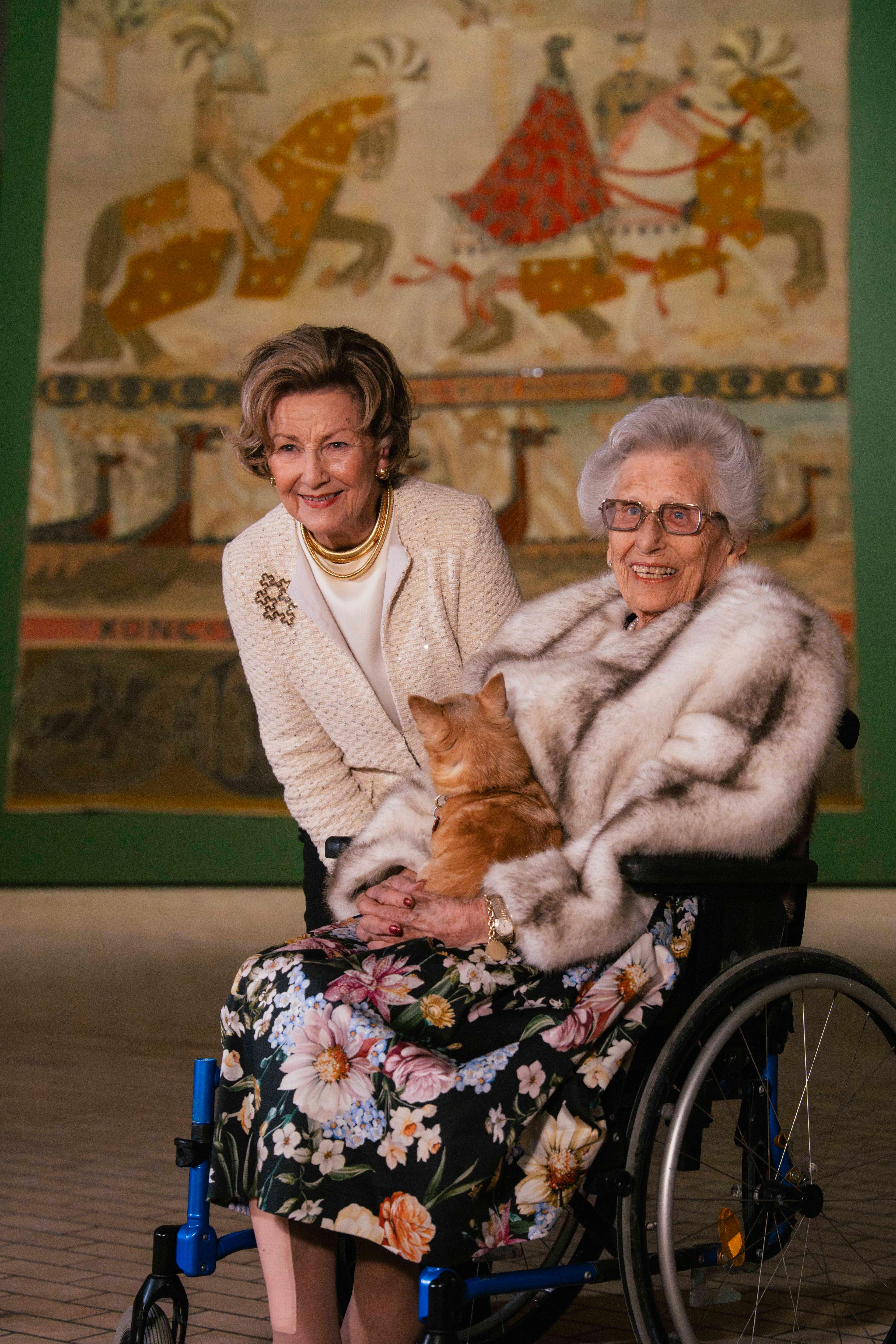 Dronning Sonja og Prinsesse Astrid med et av Riksteppene i bakgrunnen.