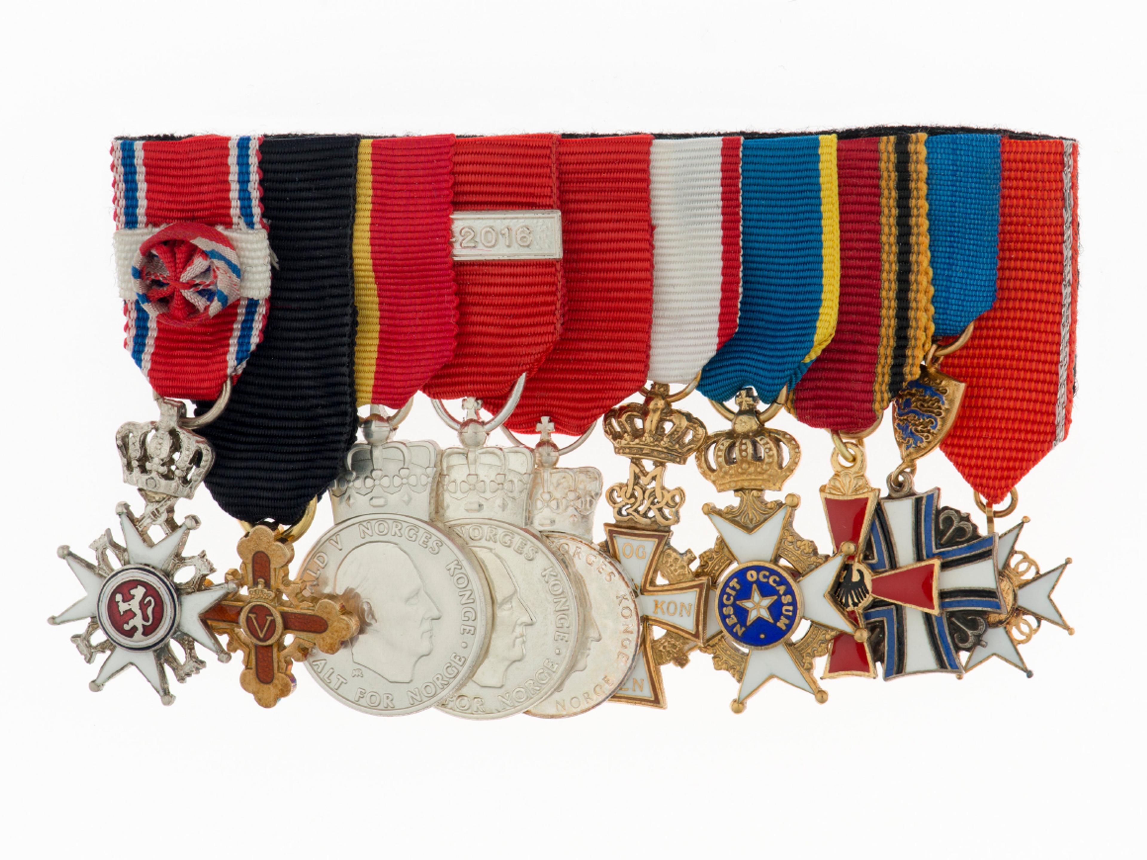 Små utgaver av ulike ordener og medaljer montert samlet.