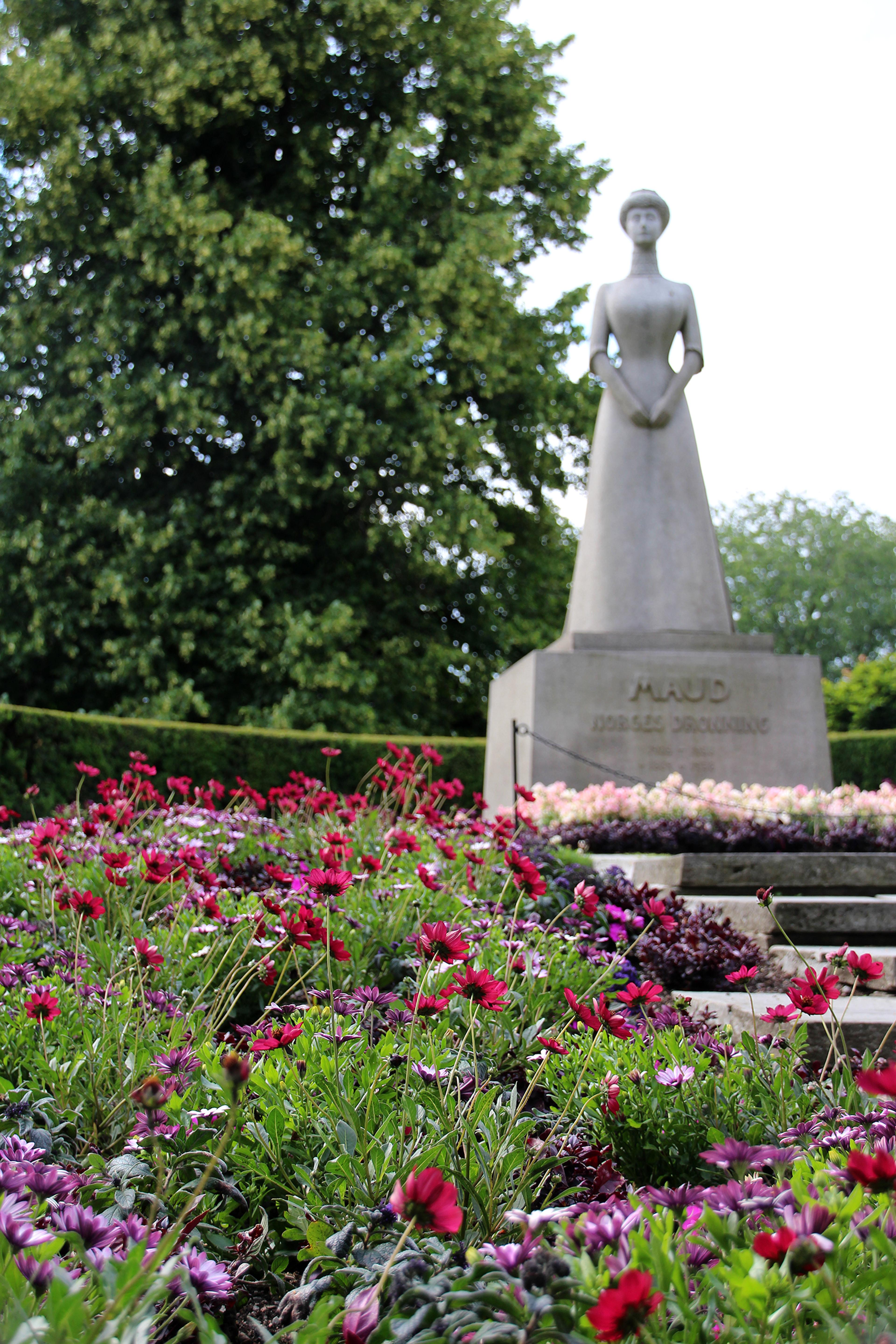Statuen av Dronning Maud bak blomster