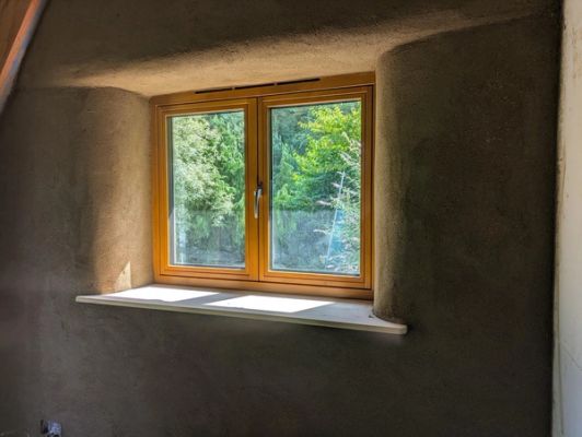 Internal window with curved walling and traditional render.