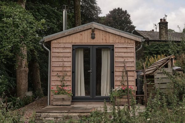 Front view of the cabin showing its french doors and flagstone patio.
