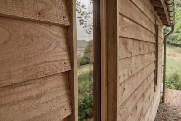 Side view of the cabin showing the custom window fittings and cladding.
