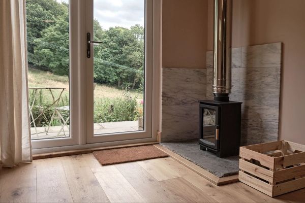 Internal view of the cabin with wood burning stove in the corner