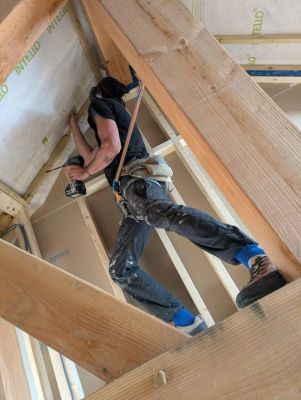 On-going work shot of airtightness and boarding work in the roof.