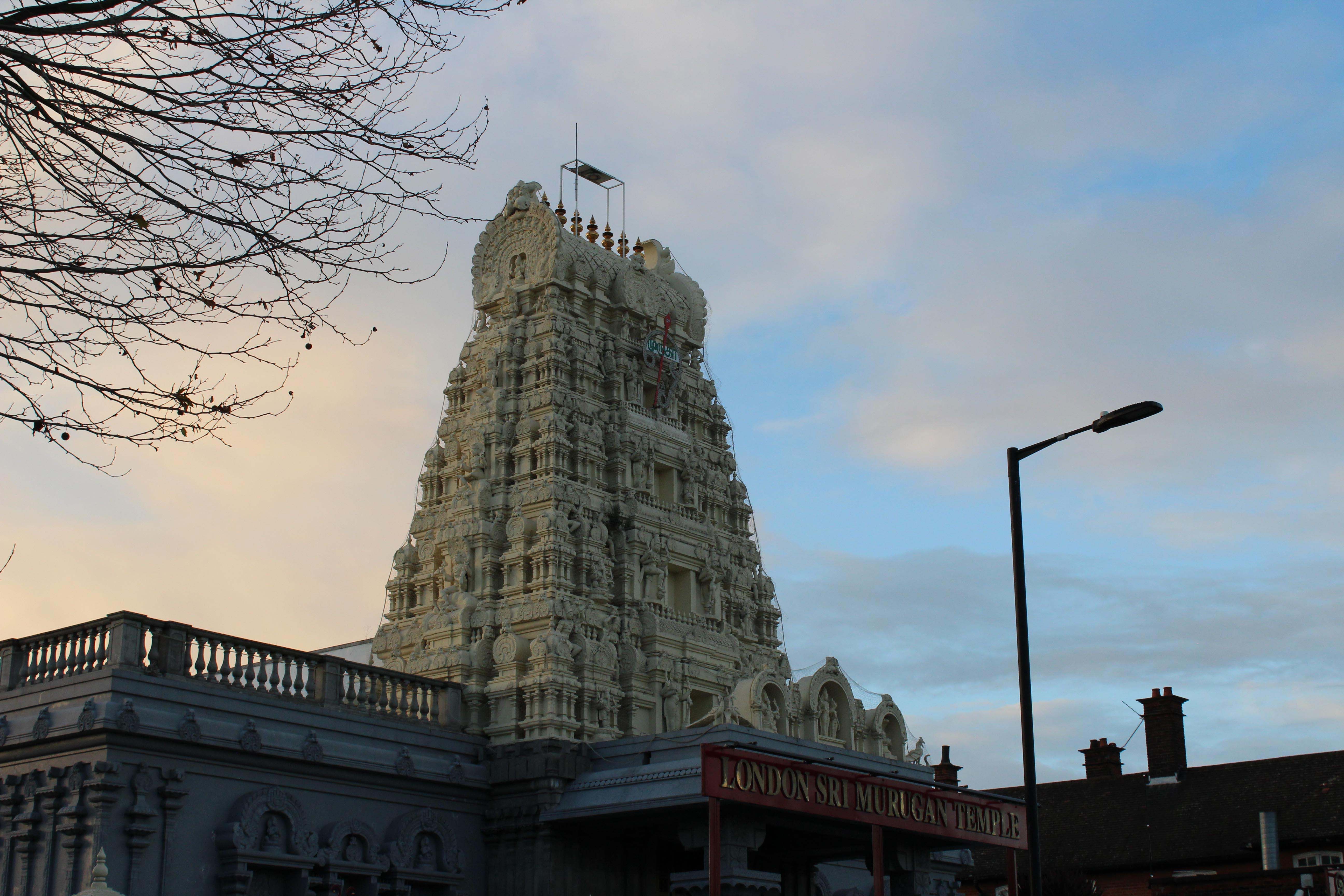 A tall temple above rising above a red sign.
