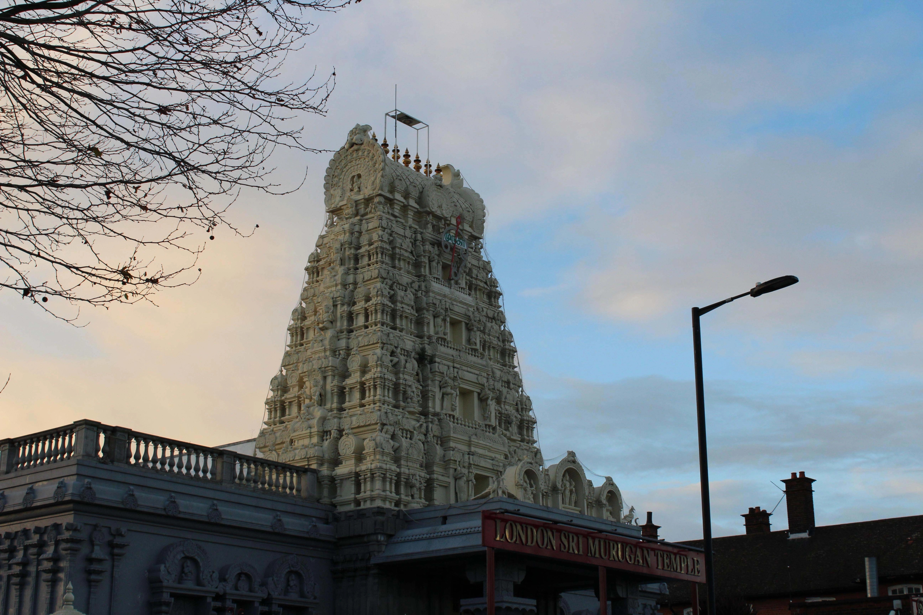 A tall temple above rising above a red sign.