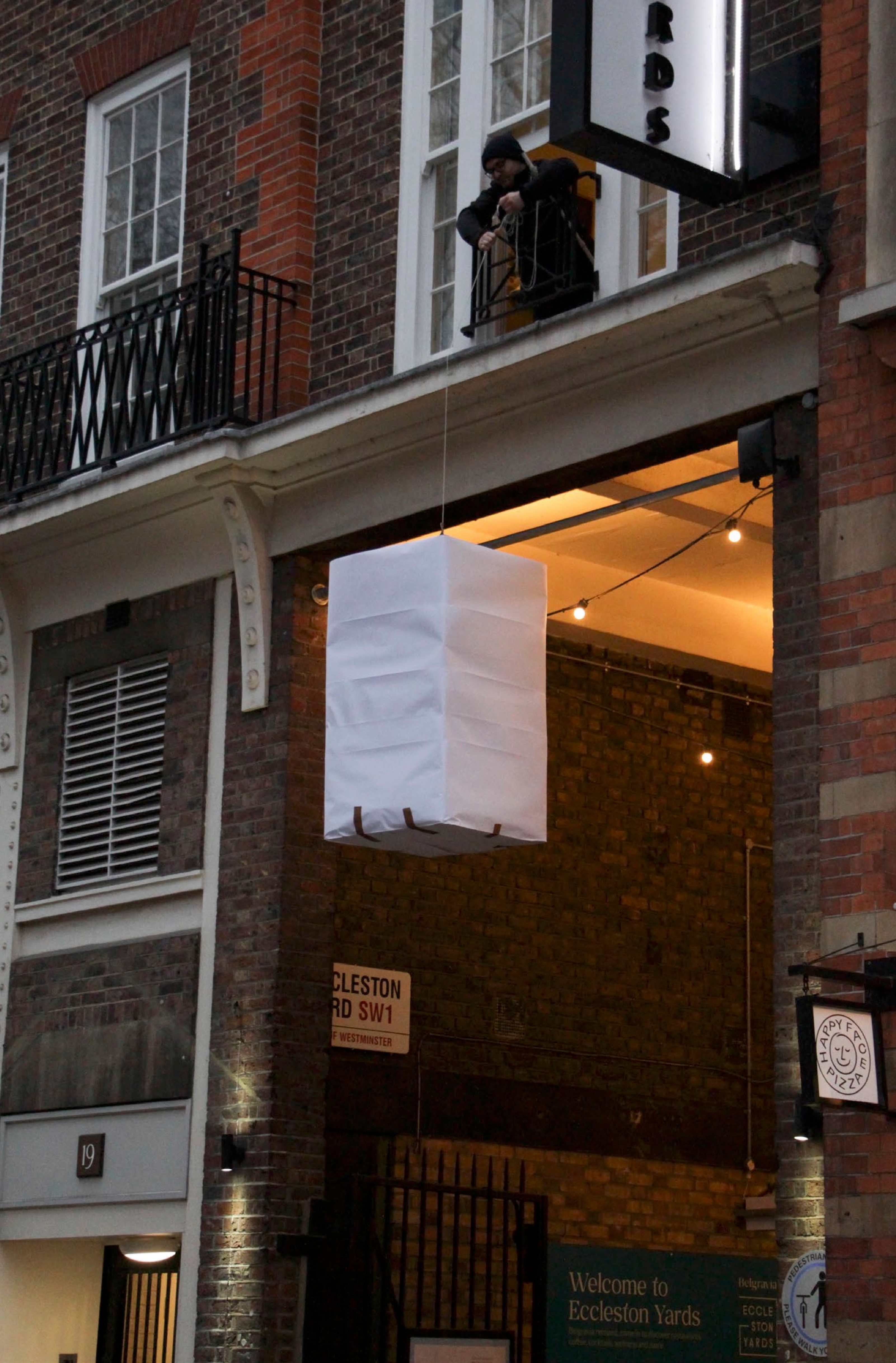 Photograph of the testing of the white lantern at the entrance of Eccleston Yards.