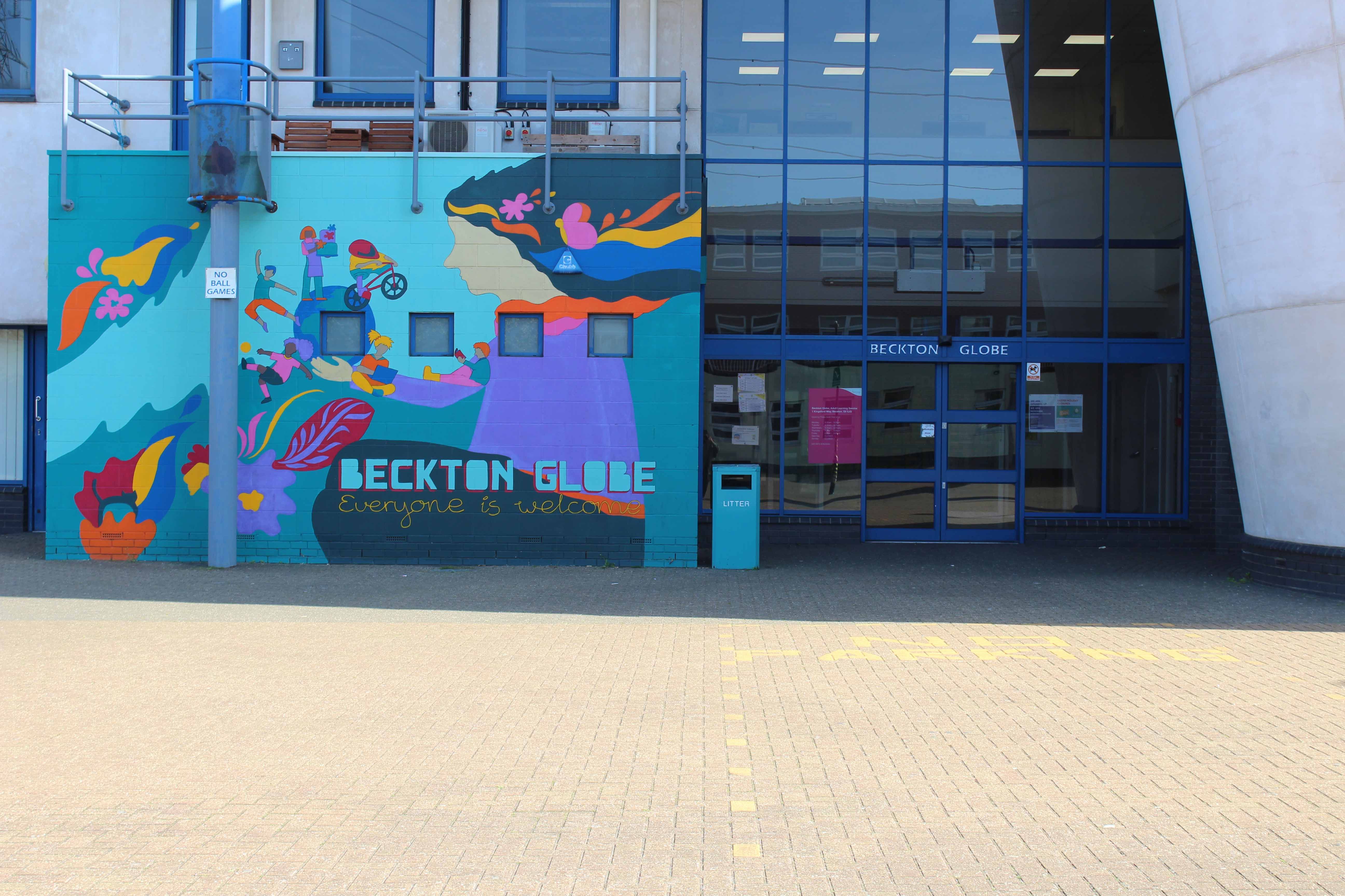 A large colourful mural at the Beckton Globe Library entrance.