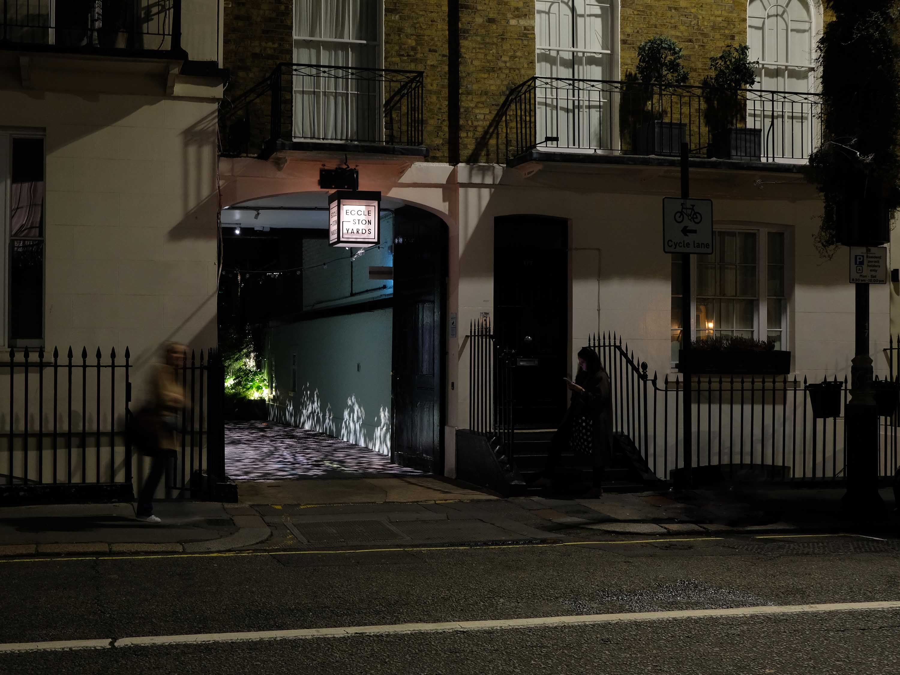 Photograph of the entrance of the courtyard at Eccleston Yards at night.
