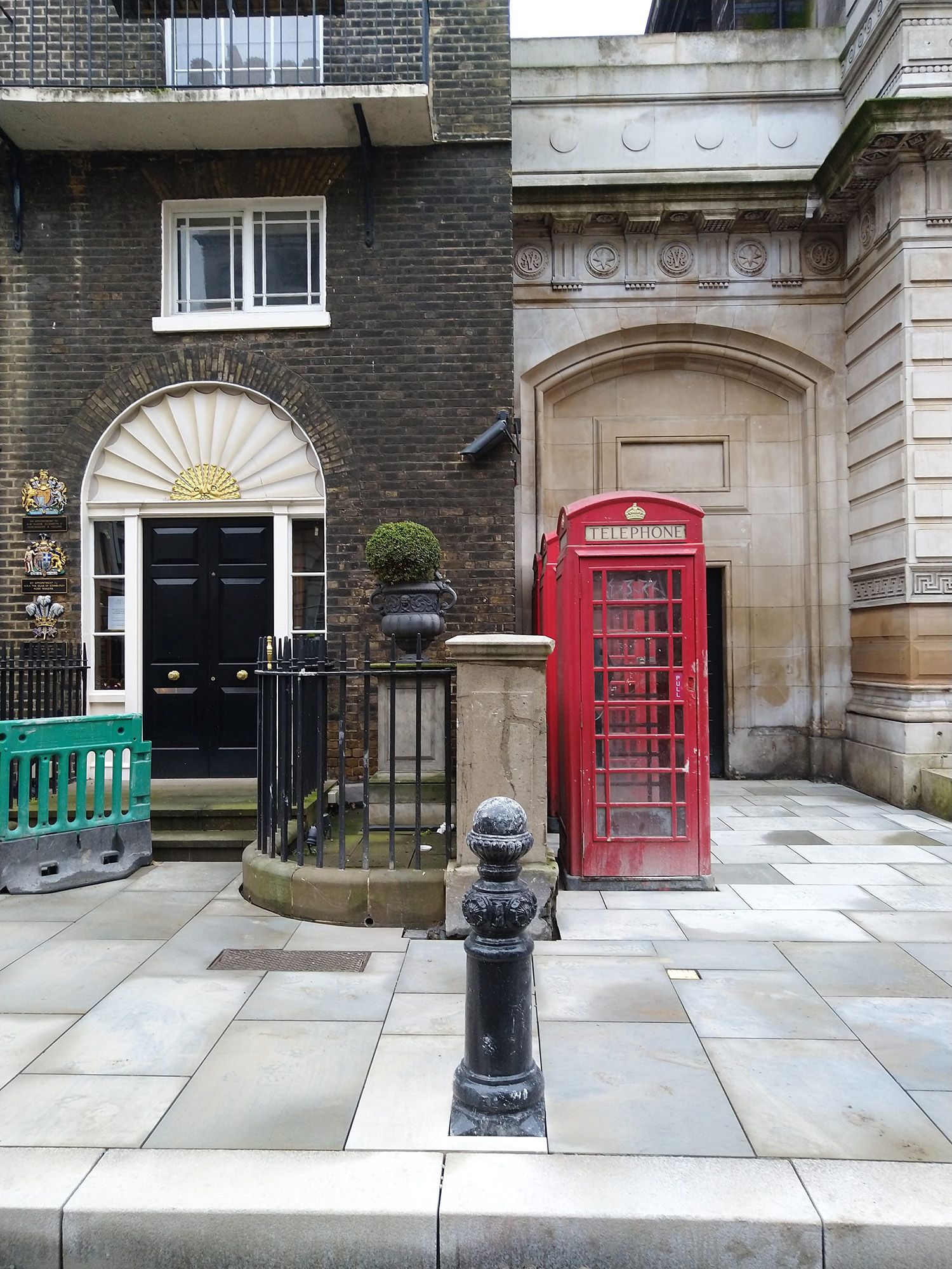Photograph of section of street with a red telephone box.