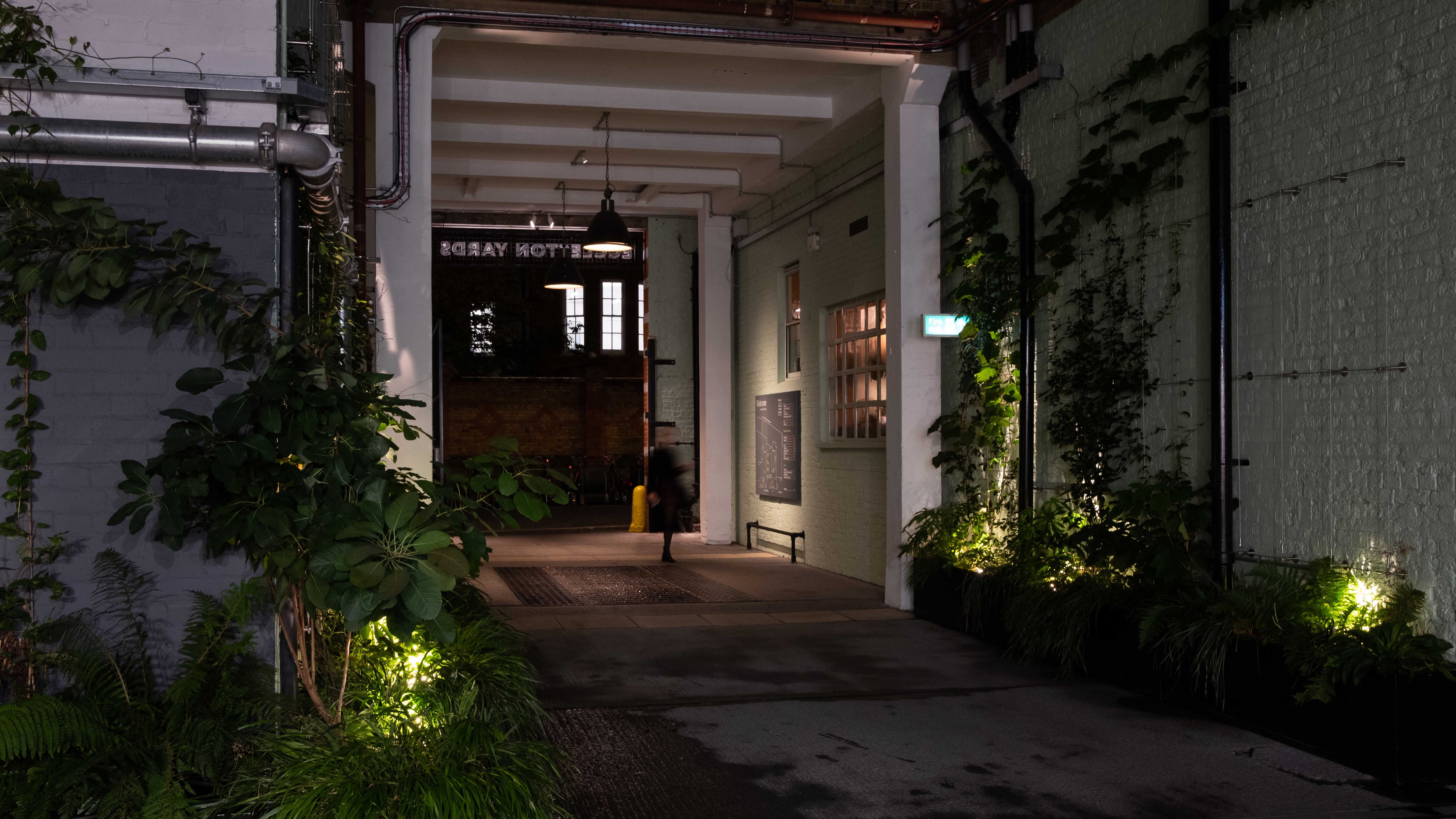 Photograph of the entrance of the courtyard at Eccleston Yards at night.