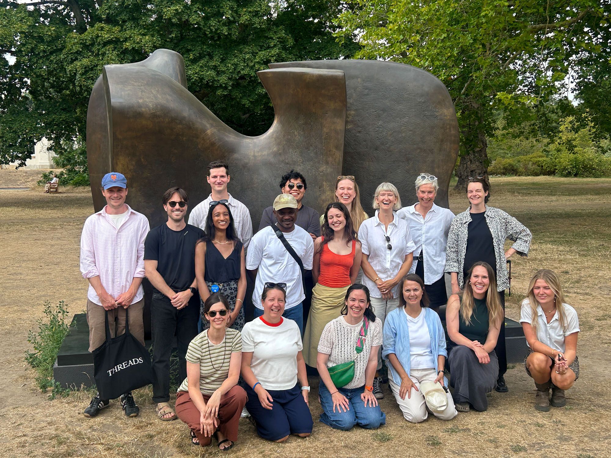 A group of people stood in front of a Henry Moore statue in Kew Gardens