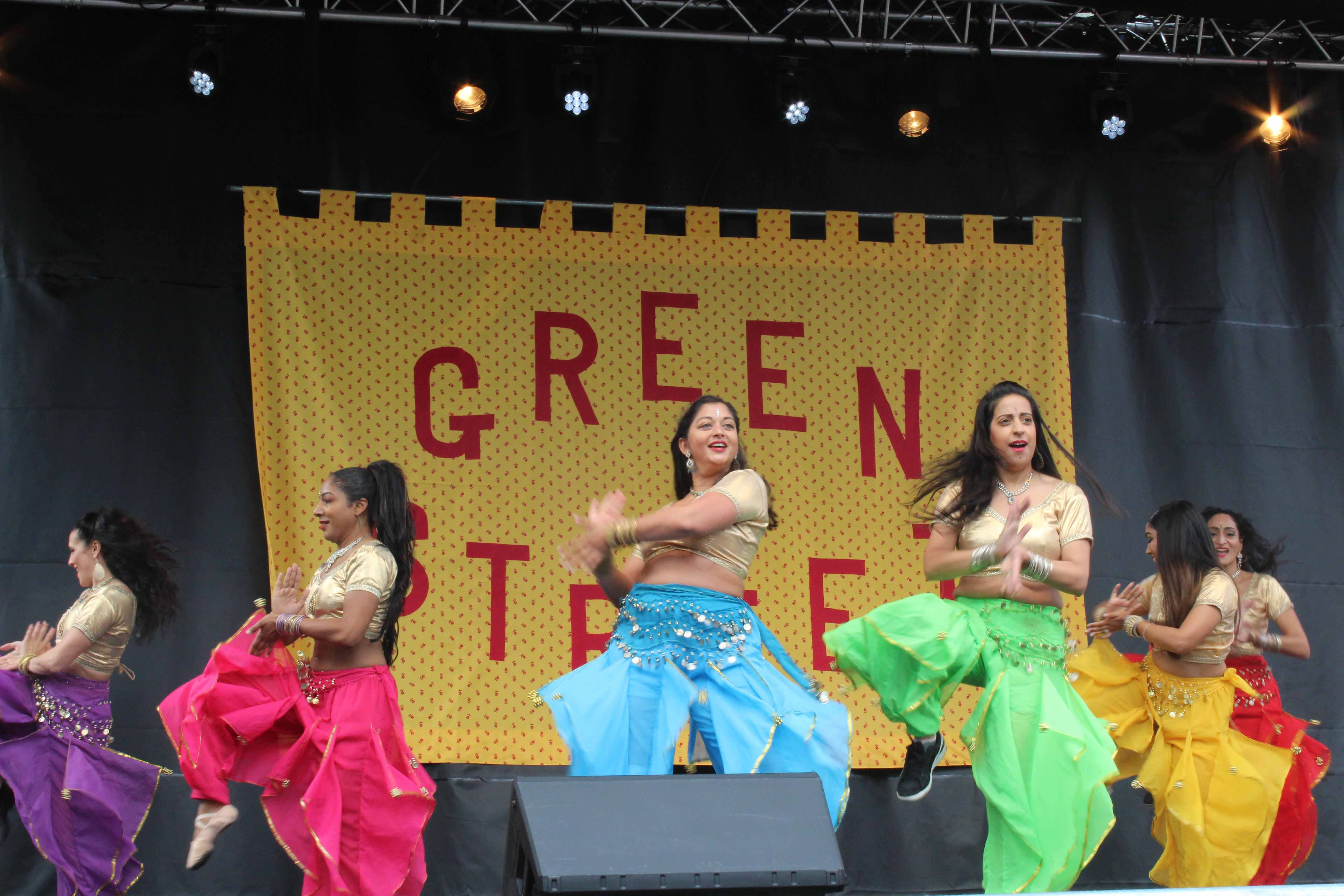 Women dancing on stage with colourful clothing