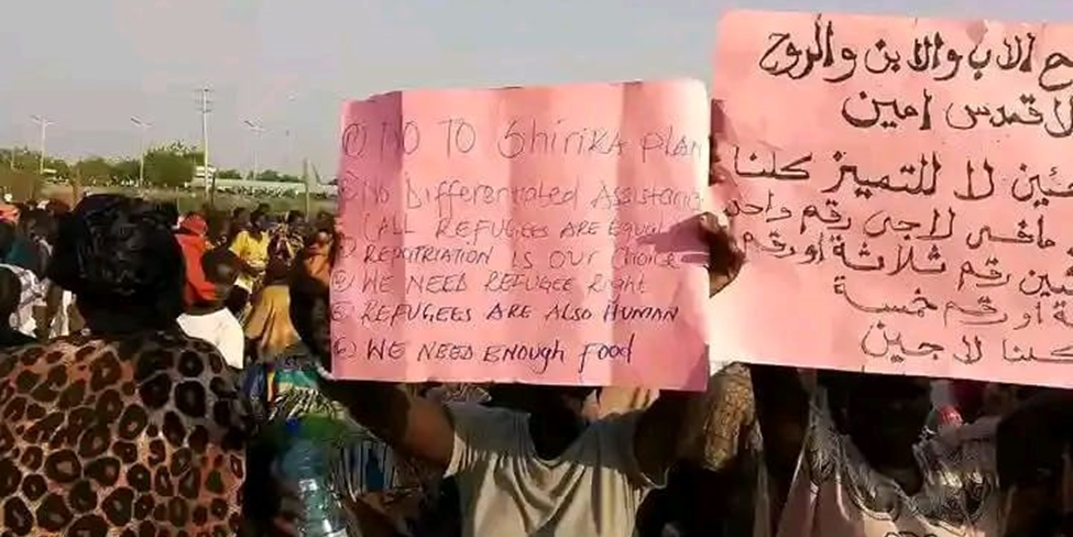 a man holds up a sign that says " no to shirika plan "