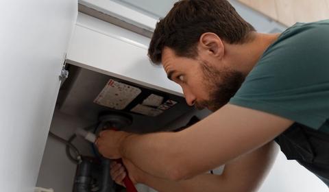 a technician repairing a furnace