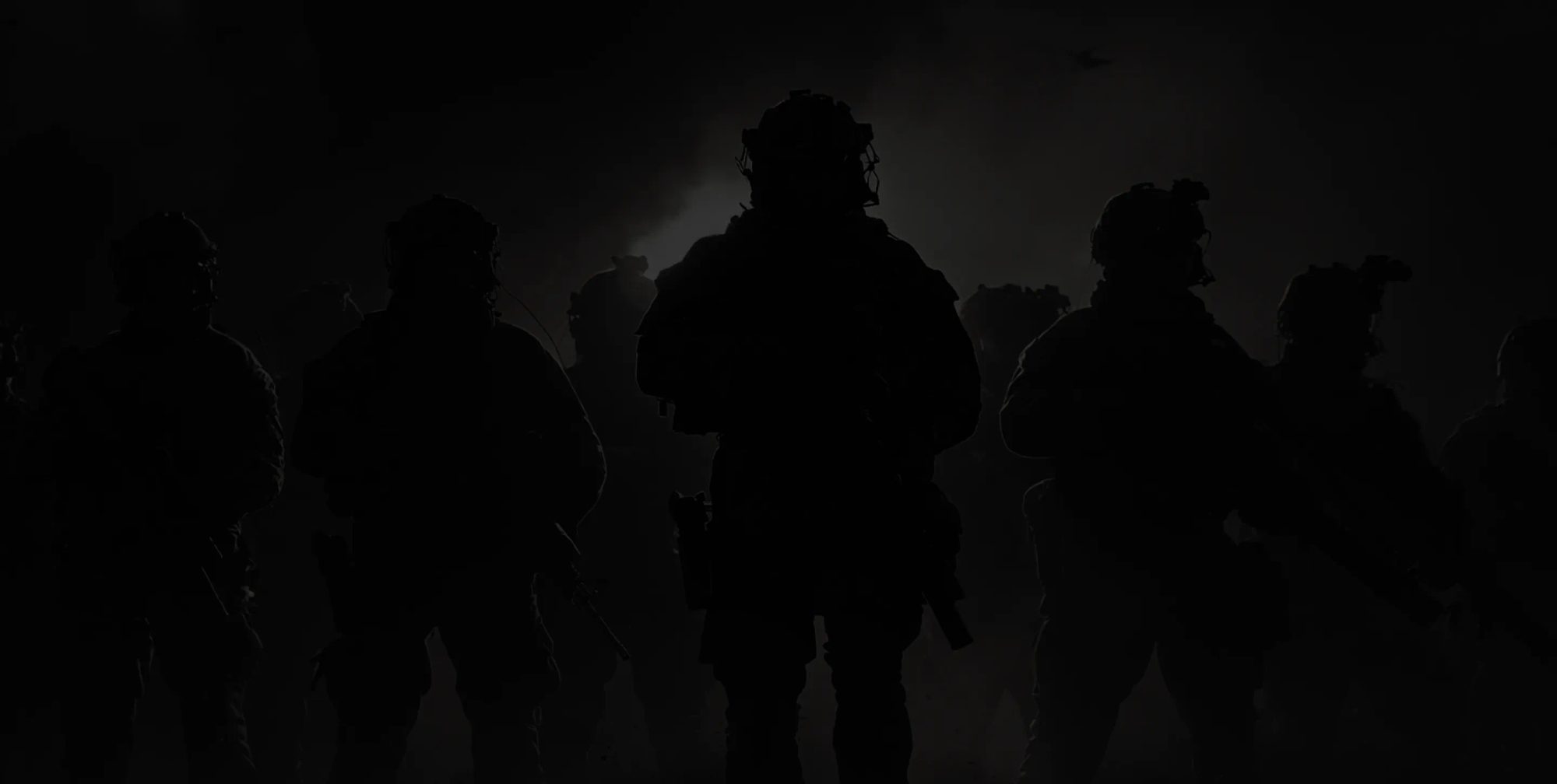 A squad in silhouette against a smoke-lit sky