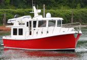Red-hulled American Tug 395 underway
