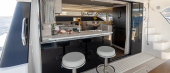 Aquila 46 Yacht aft cockpit with bar stools at the galley window