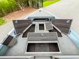 Bow of the Starcraft Storm 16 DC with the carpeted storage compartment lids open