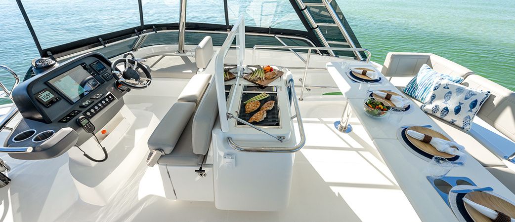 Aquila 42 Yacht flybridge with helm station and table