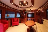 Altima 61 Pilothouse salon with cherry joinery and lounge seating