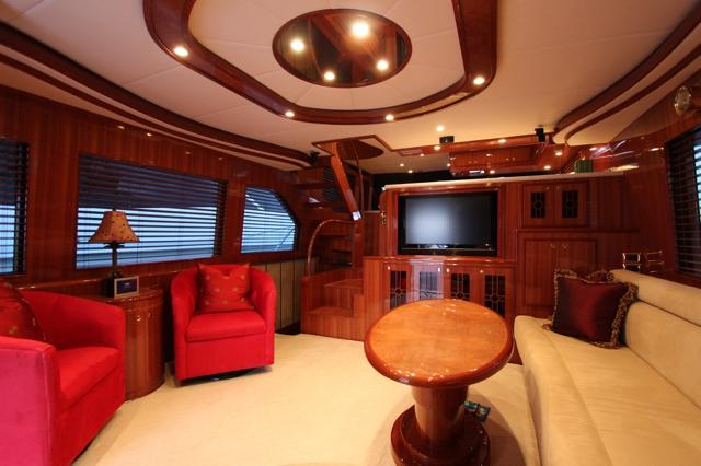 Altima 61 Pilothouse salon with cherry joinery and lounge seating
