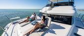 Guests relaxing on the Aquila 42 Yacht foredeck sun pad