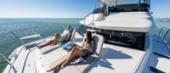 Guests relaxing on the Aquila 42 Yacht foredeck sun pad