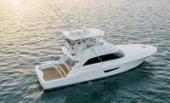 Bertram 61 Convertible aerial stern view showing the teak cockpit at sunset