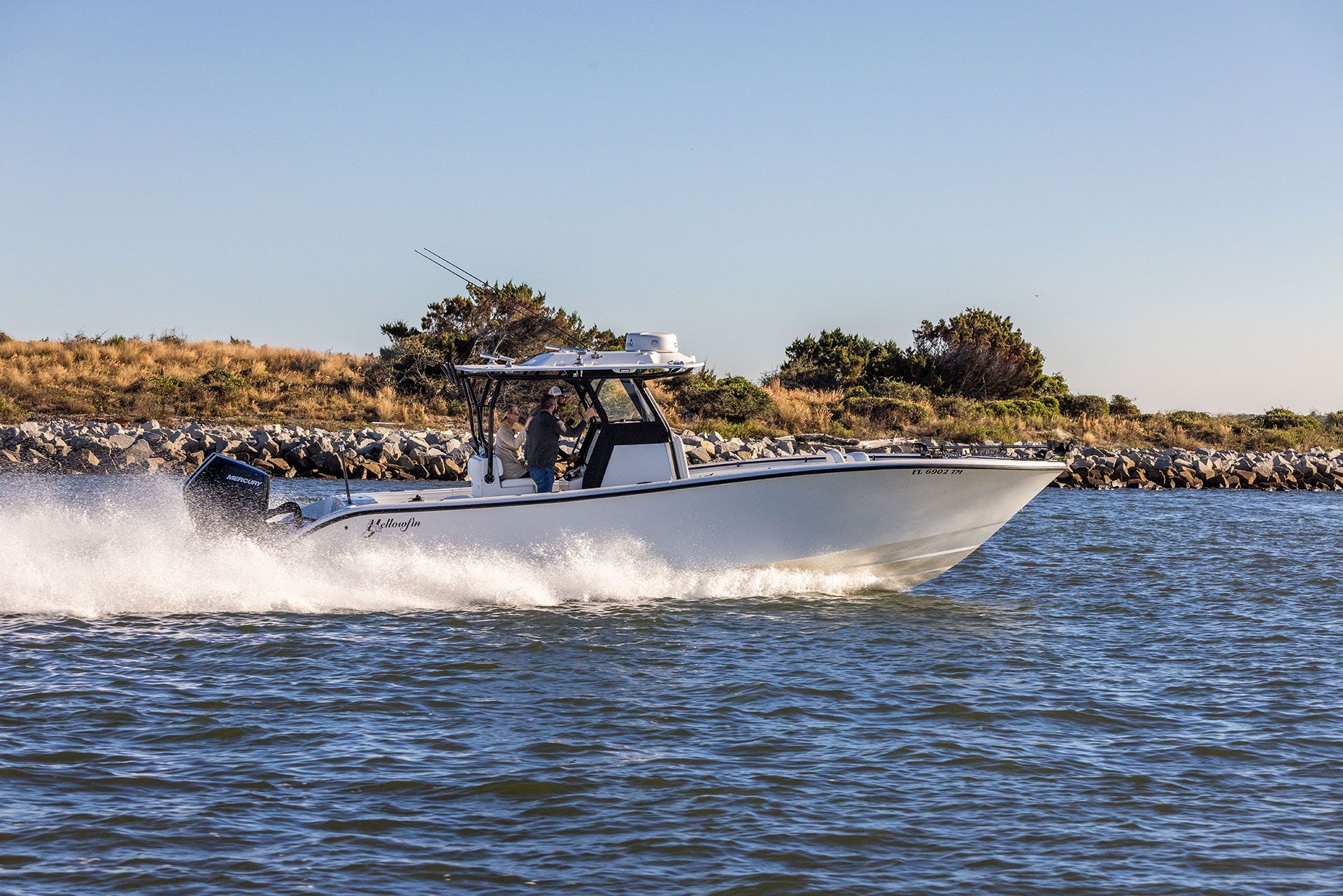Yellowfin 32 Offshore running at speed, side view, with a hardtop and twin outboards