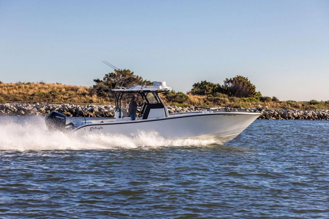 Yellowfin 32 Offshore running at speed, side view, with a hardtop and twin outboards