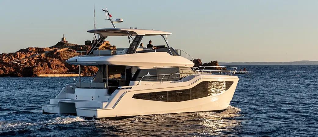 Aquila 46 Yacht cruising at sunset, port side view