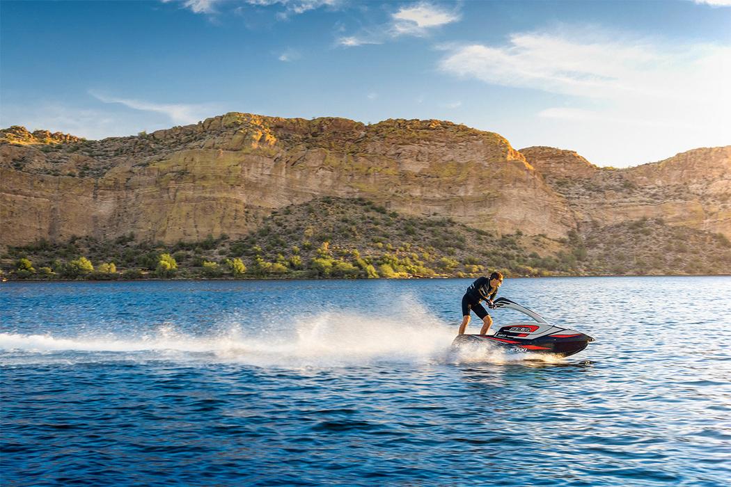 Kawasaki Jet Ski SX-R 160 rider standing on the watercraft, profile angle on the water