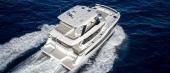 Aerial view of the Aquila 46 Yacht running at speed in deep blue water