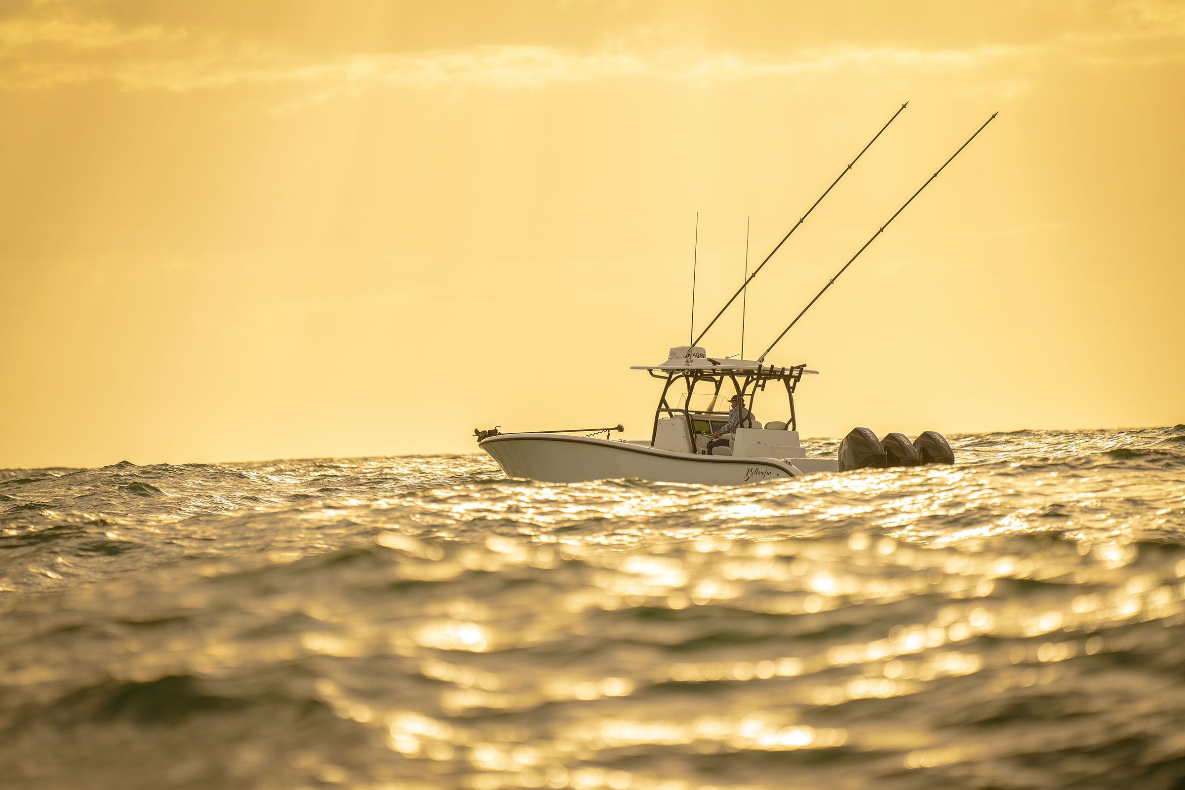 Yellowfin 34 Offshore running in calm water at sunset with twin outboards