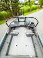 View down the open deck of the Starcraft Storm 16 DC from the stern, with two pedestal seats, dual console and wrap-around windshield