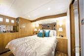 Altima 56 Pilothouse stateroom with queen bed and wood joinery