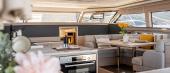 Aquila 46 Yacht salon with galley, U-shaped seating and panoramic windows
