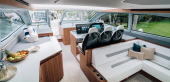 Aquila 46 Coupe salon with galley, L-shaped seating and helm seats