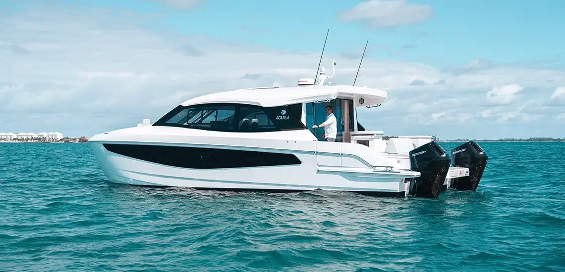 Aquila 42 Coupe at rest, port side profile with twin outboards
