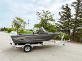 Starcraft Storm 16 DC aluminium fishing boat in side profile on its trailer, with grey hull graphics, wrap-around windshield and outboard