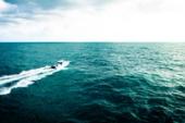 Yellowfin 34 Offshore seen from above running across open blue water