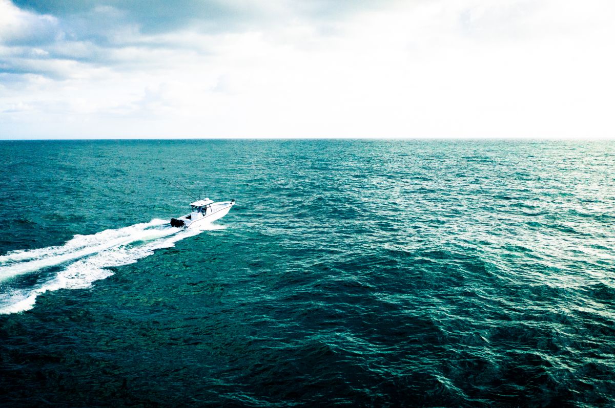 Yellowfin 34 Offshore seen from above running across open blue water