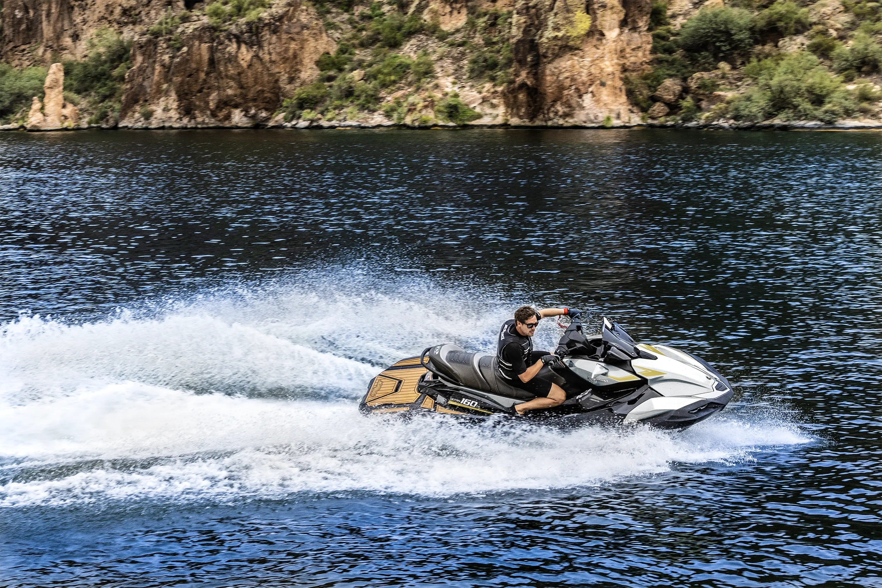 Kawasaki Jet Ski Ultra 160LX underway with riders, side view