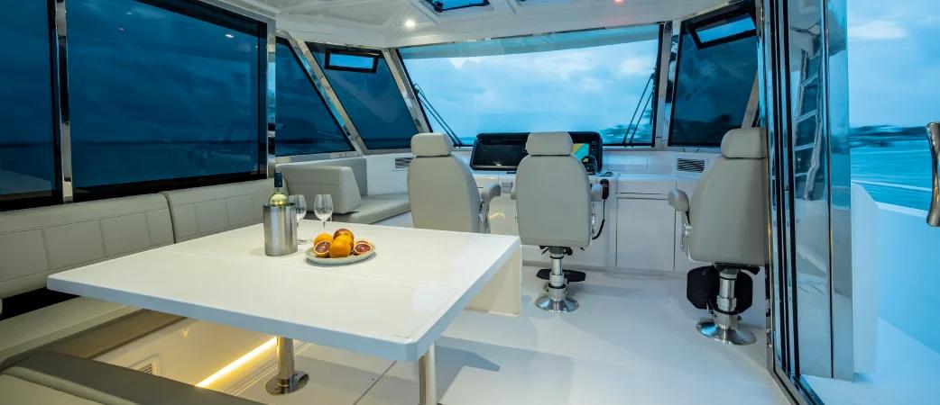 Aquila 54 Yacht enclosed flybridge with helm seats and dinette