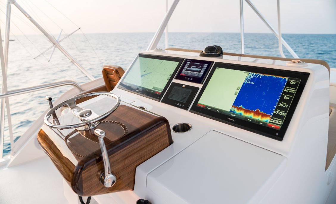 Bertram 61 Convertible flybridge helm with large displays and teak console