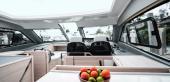 Aquila 42 Coupe salon looking forward to the helm, with skylight overhead