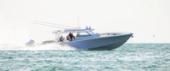 Yellowfin 54 Offshore running in bright sunlight, side view, with quad outboards