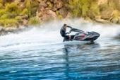 Kawasaki Jet Ski SX-R 160 rider standing on the watercraft, side angle on the water